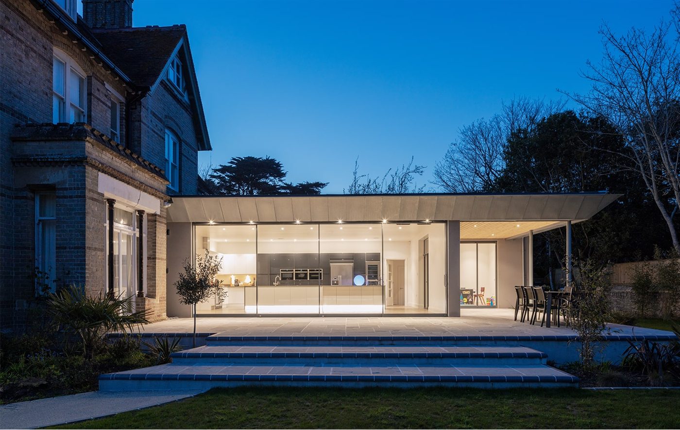 Fineline minimal-sightline sliding doors opening a contemporary kitchen extension onto a garden